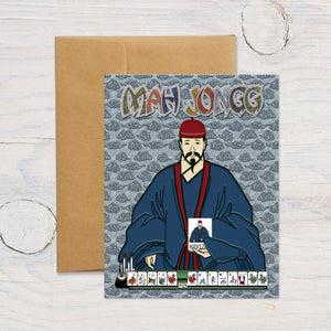 Blue Joker Greeting Card with a Mah Jongg design featuring a character in traditional attire seated at a table with game tiles. The card is marked with 'MAH JO GG' text and comes with a brown envelope.