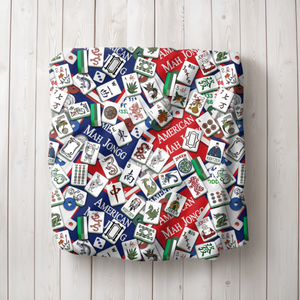 Classic American Mahjong Mania Blanket patterns draped over a white armchair.