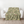 Fairytale Mah Jongg Blanket on Green, draped over a white armchair.