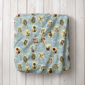 Fairytale Mahjong Land Blanket on Blue folded on wooden floor